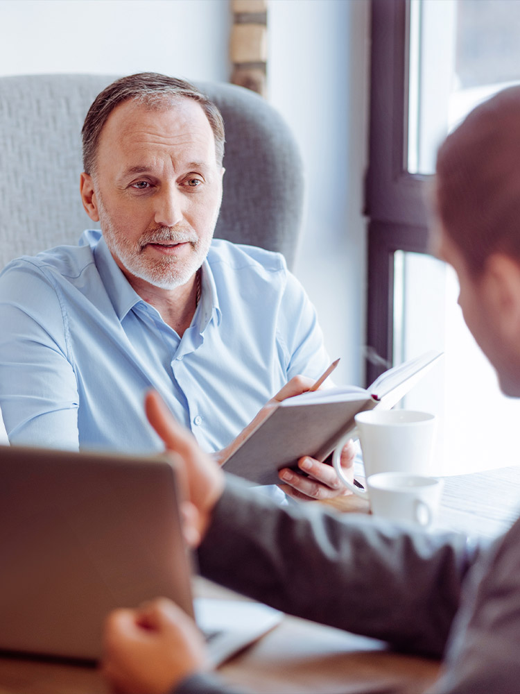 financial advisor meeting with senior to discuss annuity for retirement